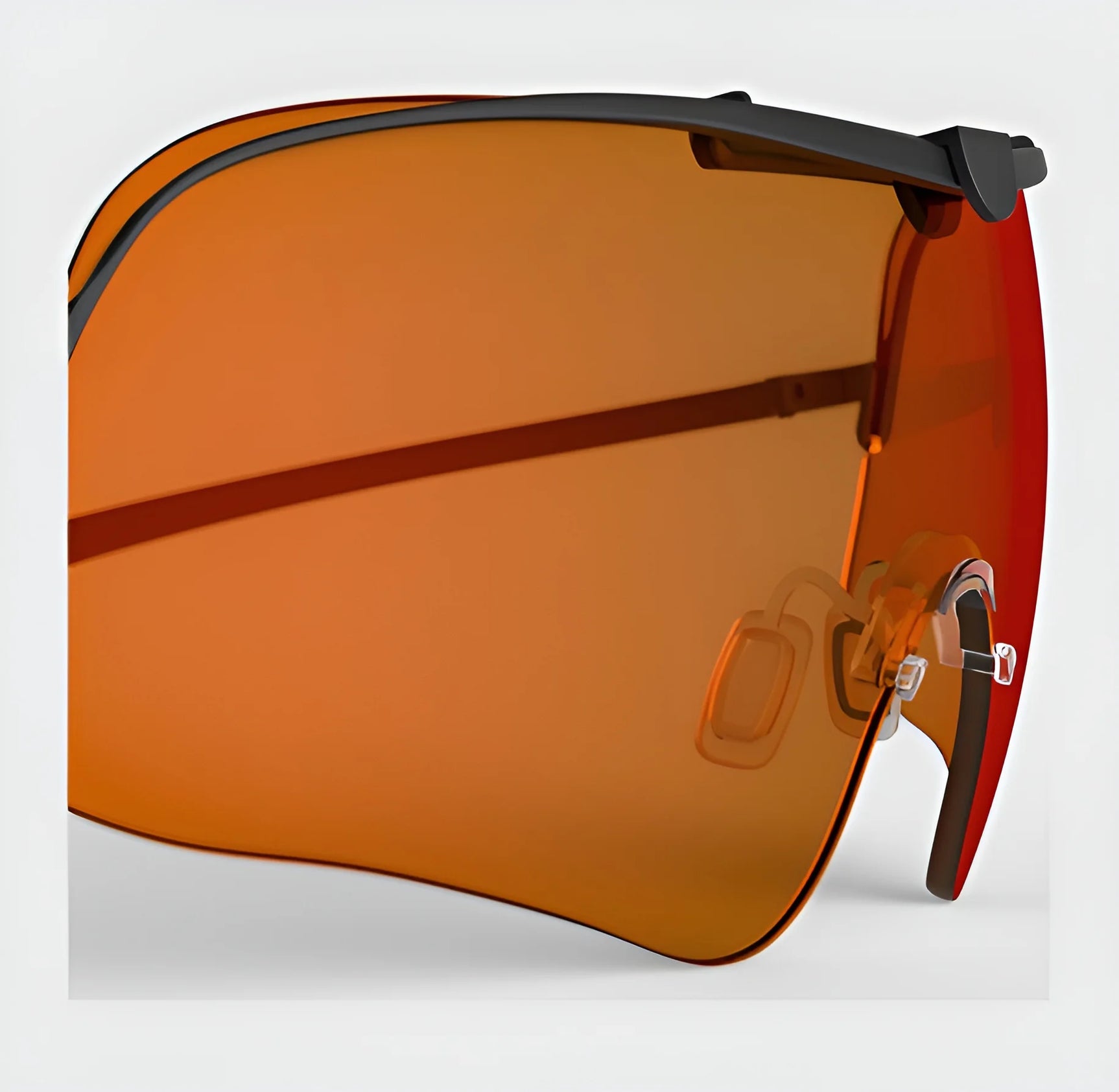 Close-up of the RE Ranger Falcon Pro Lens with a sleek black frame and amber-tinted, rimless design, featuring nose pads for optimal vision during outdoor activities.