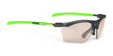 The Rudy Project Rydon Slim Sunglasses feature sporty green arms and semi-transparent lenses set against a white background, offering interchangeable lenses for ultimate versatility.