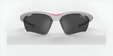 The Tifosi Optics VERO Sunglasses, size 64, feature dark lenses and a trendy white and pink frame. Ideal for smaller faces during multi-sport activities, these sunglasses combine function and flair against a light gray background.