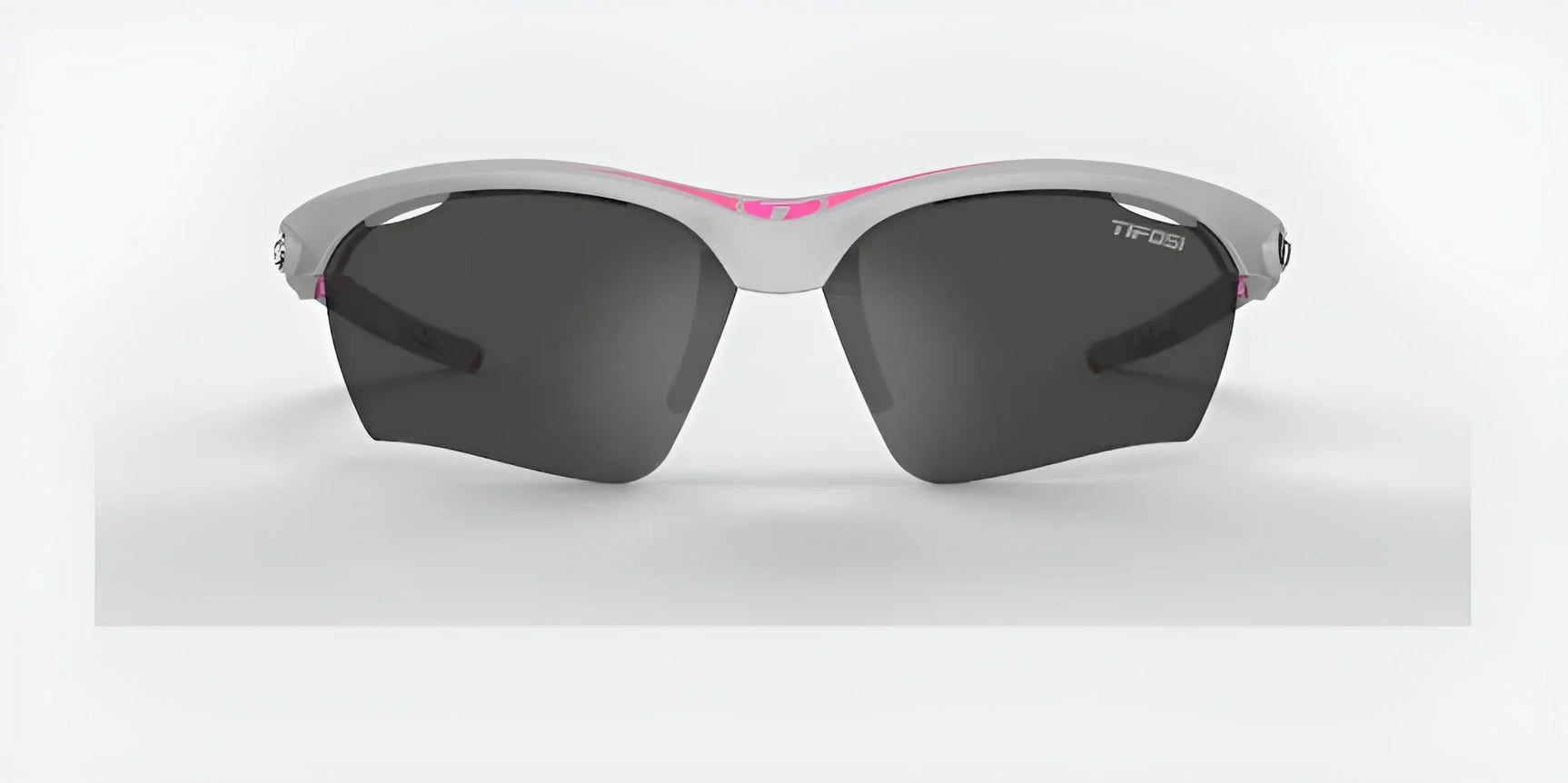 The Tifosi Optics VERO Sunglasses, size 64, feature dark lenses and a trendy white and pink frame. Ideal for smaller faces during multi-sport activities, these sunglasses combine function and flair against a light gray background.