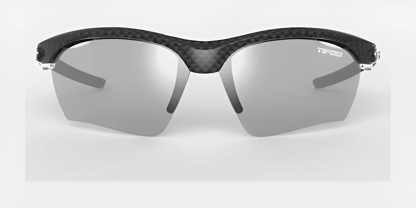 The Tifosi Optics VERO Sunglasses boast a sleek carbon fiber frame and reflective gray lenses, designed for multi-sport activities. Tailored to fit smaller faces, these sunglasses from Tifosi Optics offer both style and performance.