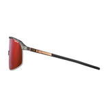 Side view of Julbo Density Sunglasses by Julbo, showcasing red-tinted lenses and a black frame with thin black and bronze arms, enhanced by CustomFit Temples for personalized comfort.