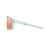 Side view of Julbo Fury sunglasses in mint green, equipped with REACTIV photochromic lenses and sleek orange reflective optics.