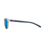 Side view of the Julbo Lizzy Sunglasses (Size 49) featuring Spectron 3 lenses with blue tint, a clear frame, and dark blue arms with a pink logo.