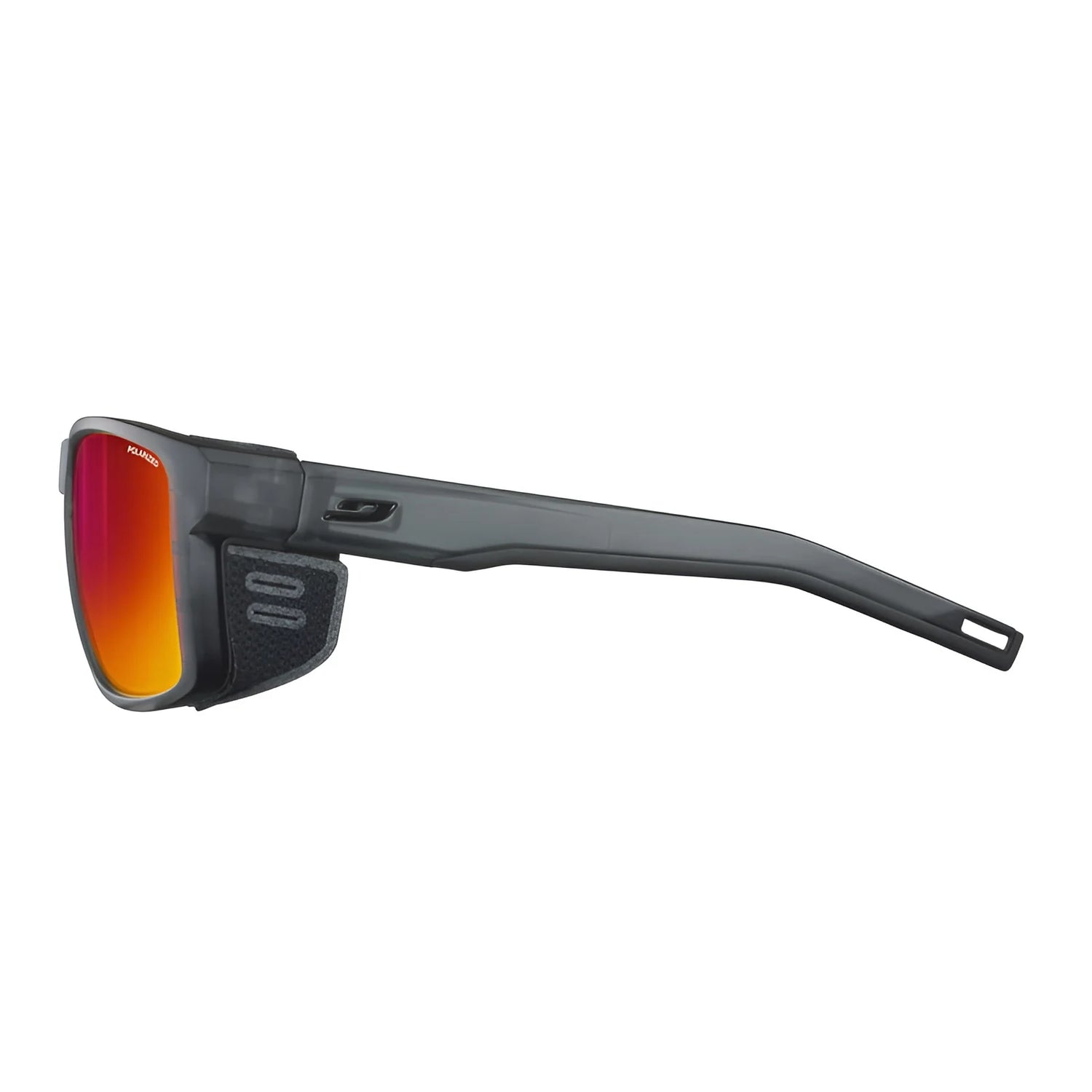 Side view of Julbo Shield Sunglasses, Size 59, from Julbo, highlighting the sleek dark frame with orange-tinted lenses and Grip Nose technology for a secure fit. With Air Flow ventilation for comfort on active adventures, showcased against a pristine white background.