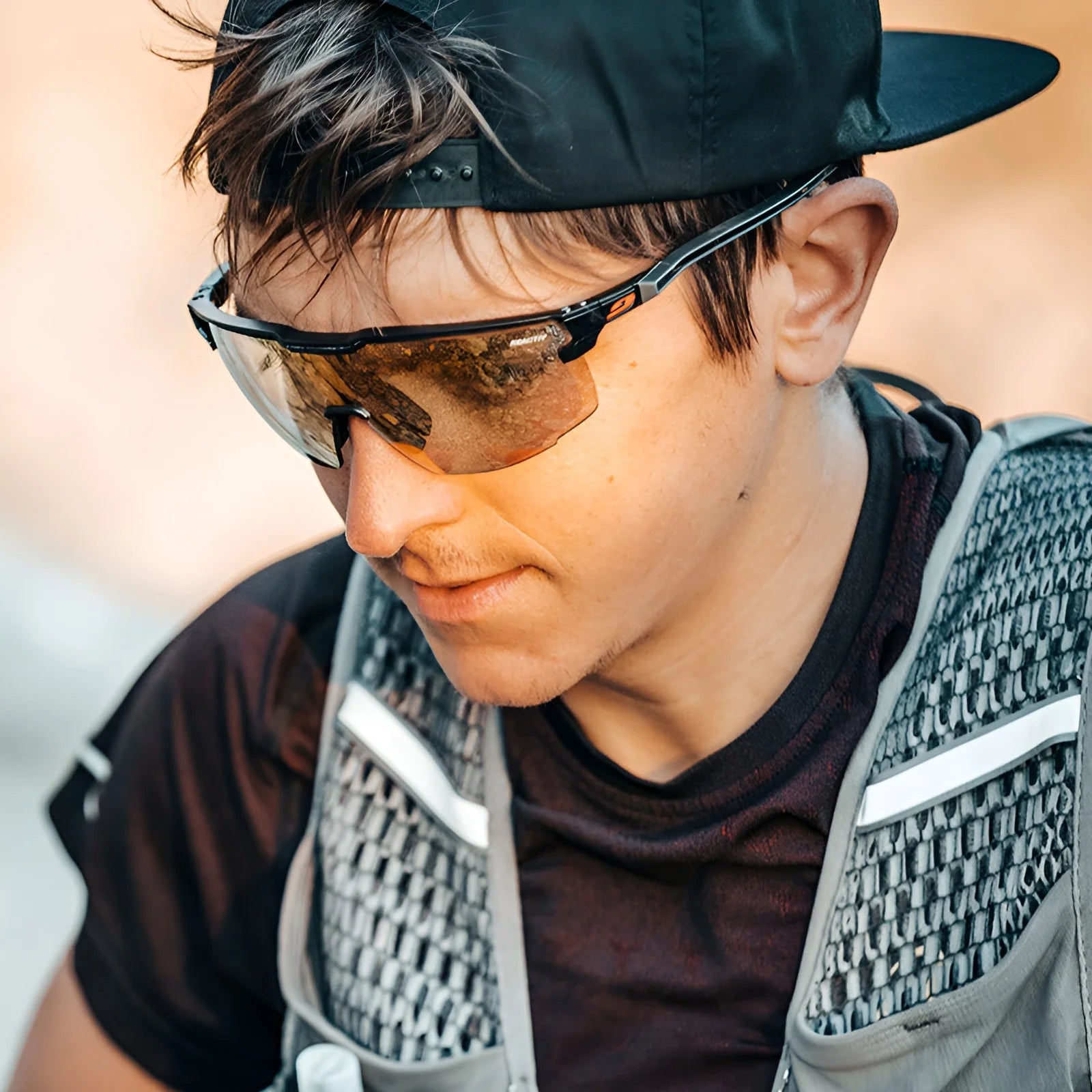 Enjoy ultimate freedom in sport with a secure-fit cap and Julbo's Ultimate Sunglasses. These reflective sunglasses, featuring a panoramic lens, provide the perfect look while gazing downward outdoors.